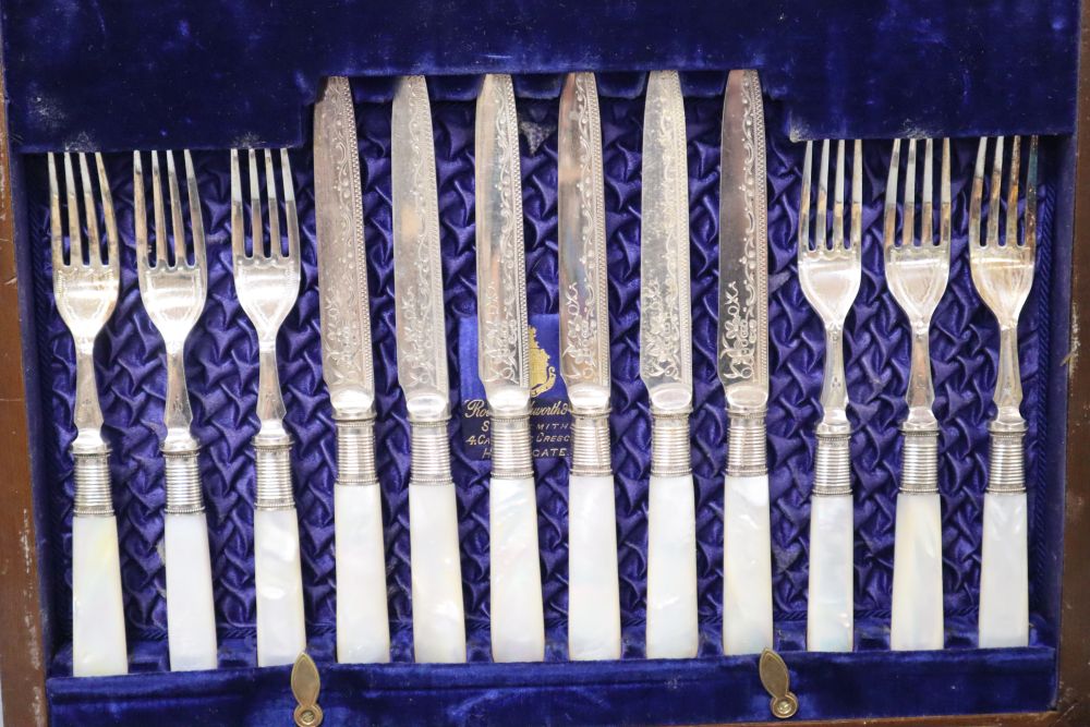 A Victorian electroplate egg cruet stand and cased set of fruit knives and forks